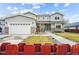 Charming home exterior with a three-car garage and well manicured front yard and fence at 3165 W 63Rd Ave, Denver, CO 80221