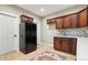 An inviting kitchen boasts wood cabinets, a modern fridge, and a stylish backsplash at 3165 W 63Rd Ave, Denver, CO 80221