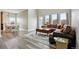Spacious living room with hardwood floors, large windows, and a comfortable couch, perfect for relaxing at 3165 W 63Rd Ave, Denver, CO 80221