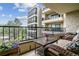 Private balcony with comfortable seating and scenic view of building architecture and landscaping at 13961 E Marina Dr # 414, Aurora, CO 80014