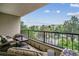 Relaxing balcony seating area overlooking lush landscaping and a neighborhood view at 13961 E Marina Dr # 414, Aurora, CO 80014