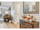 Inviting entryway with hardwood floors, a wooden cabinet decorated with fall foliage, and a view into the living room at 13961 E Marina Dr # 414, Aurora, CO 80014