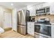 Modern kitchen featuring stainless steel appliances, white cabinets, granite countertop, and hardwood floors at 13961 E Marina Dr # 414, Aurora, CO 80014