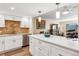 Modern kitchen featuring stainless steel appliances, white cabinets, granite countertop, and a central island at 13961 E Marina Dr # 414, Aurora, CO 80014