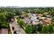 Stunning aerial view of a modern home with solar panels nestled among lush trees and close to the city at 3690 W Byron Pl, Denver, CO 80211