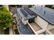 Close aerial shot of a home featuring solar panels, a deck, and modern architecture in a vibrant neighborhood at 3690 W Byron Pl, Denver, CO 80211