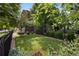 Beautiful backyard featuring lush grass, landscape, and black fence at 3690 W Byron Pl, Denver, CO 80211
