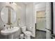 Bathroom with pedestal sink and an open view into the walk-in glass shower at 3690 W Byron Pl, Denver, CO 80211