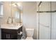 Bathroom with vanity, large mirror, and glass-enclosed shower with white tile at 3690 W Byron Pl, Denver, CO 80211