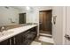 Bathroom featuring a long double vanity, with mosaic tile backsplash, and walk-in glass shower at 3690 W Byron Pl, Denver, CO 80211