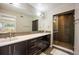 Bathroom featuring a long double vanity, with mosaic tile backsplash, and walk-in glass shower at 3690 W Byron Pl, Denver, CO 80211