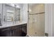 Bathroom featuring a glass door shower, a modern vanity, and neutral finishes at 3690 W Byron Pl, Denver, CO 80211