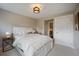 Bright bedroom with white bedding, modern lighting, and a convenient bedside table at 3690 W Byron Pl, Denver, CO 80211