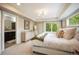 Bedroom showcasing a cozy bed, a decorative painting, and an ensuite bathroom at 3690 W Byron Pl, Denver, CO 80211