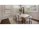 Bright dining room featuring stylish table, chairs, contemporary decor and white rug at 3690 W Byron Pl, Denver, CO 80211