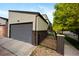Exterior side view of the home featuring a garage with neutral color palette at 3690 W Byron Pl, Denver, CO 80211