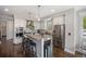 Bright and modern kitchen featuring stainless steel appliances and a central island at 3690 W Byron Pl, Denver, CO 80211