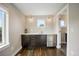 Bright kitchenette featuring dark cabinets, stainless steel beverage center, and white countertops at 3690 W Byron Pl, Denver, CO 80211