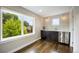 Bright kitchenette featuring dark cabinets, stainless steel beverage center, and large window at 3690 W Byron Pl, Denver, CO 80211