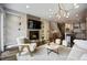 Bright living room with a modern fireplace, stylish decor and access to the kitchen at 3690 W Byron Pl, Denver, CO 80211