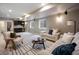 Spacious living room featuring a wet bar, stylish sofas, and a striped area rug at 3690 W Byron Pl, Denver, CO 80211