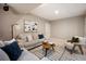 Comfortable living room featuring neutral tones, stylish sofas, and a striped area rug at 3690 W Byron Pl, Denver, CO 80211