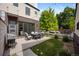 Charming patio with outdoor furniture, grill, and well-manicured lawn at 3690 W Byron Pl, Denver, CO 80211