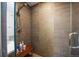 Shower featuring neutral tiling, a shower bench, and bronze shower head at 3690 W Byron Pl, Denver, CO 80211