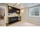 Attractive wet bar features dark cabinetry, sleek countertops, and a beverage cooler at 3690 W Byron Pl, Denver, CO 80211