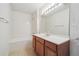 Bright bathroom featuring a vanity with wooden cabinets, a large mirror, and a shower-tub combination at 4875 S Balsam Way # 6-102, Littleton, CO 80123