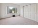 Bright bedroom featuring a large window with outdoor views and a closet with sliding doors at 4875 S Balsam Way # 6-102, Littleton, CO 80123
