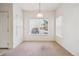 Well-lit dining room with neutral carpet, white walls, and a large window with blinds at 4875 S Balsam Way # 6-102, Littleton, CO 80123