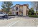 Inviting condo exterior with stone accents, private balcony, reserved parking, and lush landscaping at 4875 S Balsam Way # 6-102, Littleton, CO 80123