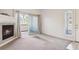 Inviting living room with a fireplace, sliding door to a balcony, and bright natural light at 4875 S Balsam Way # 6-102, Littleton, CO 80123