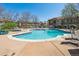 Community pool is surrounded by lounge chairs and lush landscaping, perfect for relaxing and soaking up the sun at 4875 S Balsam Way # 6-102, Littleton, CO 80123