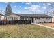 Well-maintained home exterior featuring a manicured lawn, black fence, and inviting entrance at 225 Niagara St, Denver, CO 80220