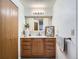 Well-lit bathroom featuring a wooden vanity with framed mirror at 7700 N Depew St # 1518, Arvada, CO 80003