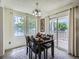 Bright dining room with natural light, neutral walls, a stylish chandelier, and slider doors to the outside at 7700 N Depew St # 1518, Arvada, CO 80003