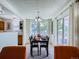 Inviting dining area with slider doors to the outside, two windows and two orange chairs in the foreground at 7700 N Depew St # 1518, Arvada, CO 80003