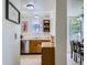 Functional kitchen with stainless steel dishwasher, wooden cabinets, and adjacent dining area at 7700 N Depew St # 1518, Arvada, CO 80003