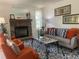 Cozy living room features a stone fireplace, comfortable seating, and a stylish rug at 7700 N Depew St # 1518, Arvada, CO 80003
