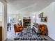 Spacious living room with fireplace and view to dining and balcony, perfect for relaxing or entertaining at 7700 N Depew St # 1518, Arvada, CO 80003