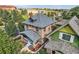An elevated exterior shows the architectural details and new roof of this lovely brick home at 2854 Eliot St, Denver, CO 80211