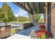 A welcoming covered front porch with brick pillars offering a view of the neighborhood park across the street at 2854 Eliot St, Denver, CO 80211