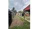 A cluttered backyard shows refrigerators along a dirt path, leading to a run-down area with a weathered jacuzzi at 2655 Pontiac St, Denver, CO 80207