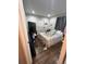 A bedroom featuring hardwood floors, a window, and a bed covered in patterned linens at 2655 Pontiac St, Denver, CO 80207