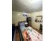 A basement bedroom with a mini fridge and small window at 2655 Pontiac St, Denver, CO 80207