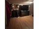 A bedroom featuring a dark dresser and laminated wood flooring at 2655 Pontiac St, Denver, CO 80207