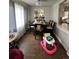 Cozy dining area with hardwood floors, a modern dining table, and ample natural light from nearby windows at 2655 Pontiac St, Denver, CO 80207