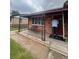 Inviting front porch with decorative iron railings and a bright red front door at 2655 Pontiac St, Denver, CO 80207